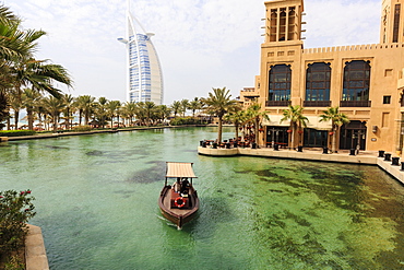 Dhows cruise around the Madinat Jumeirah Hotel with Burj Al Arab in the background, Dubai, United Arab Emirates, Middle East 