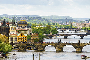 Prague cityscape looking down the Vltava River at its bridges connecting the Old Town to Mala Strana, Prague Castle and Hradcany, Prague, Czech Republic, Europe