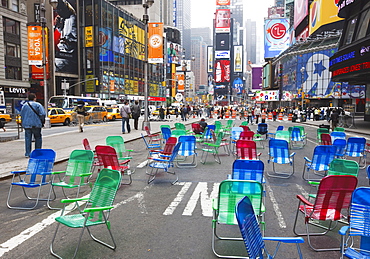 Garden chairs in the road for the public to sit in the pedestrian zone of Times Square, New York City, New York, United States of America, North America