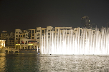 The Dubai Fountain, the largest of its kind in the world that shoots water 150 metres into the air to accompanying music and light show and stands in front of the Burj Khalifa, formerly the Burj Dubai, Downtown Burj Dubai, United Arab Emirates, Middle East