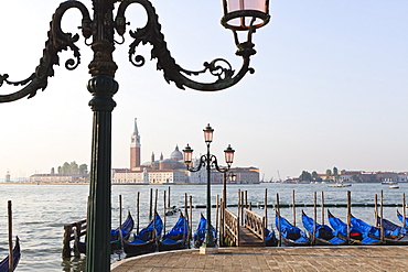 Gondolas moored on the Lagoon, San Giorgio Maggiore beyond, Riva degli Schiavoni, Venice, UNESCO World Heritage Site, Veneto, Italy, Europe