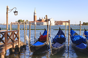 Gondolas moored on the Lagoon, San Giorgio Maggiore beyond, Riva degli Schiavoni, Venice, UNESCO World Heritage Site, Veneto, Italy, Europe