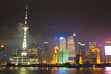 Pudong skyline at night across the Huangpu River, Oriental Pearl tower on left, Shanghai, China, Asia