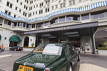 The Peninsula Hotel and one of the hotel's fleet of green Rolls Royces, Hong Kong, China, Asia