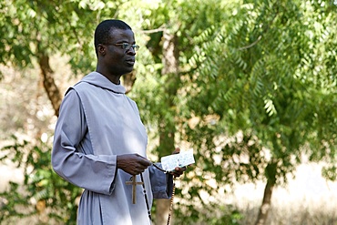 Catholic friar holding rosary and prayer book, Popenguine, Thies, Senegal, West Africa, Africa