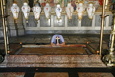 Worshipper at the Stone of the Anointing, Church of the Holy Sepulchre, Jerusalem, Israel, Middle East