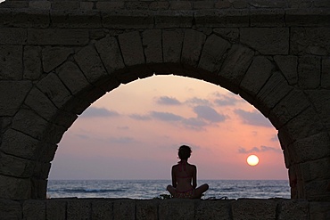 Girl watching sunset in Cesarea, Israel, Middle East