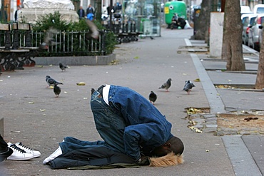 Muslim at prayer in a street, Paris, France, Europe