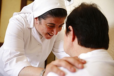 Daughter of Charity comforting a handicapped person in a center run by the Daughters of Charity in Jerusalem, Israel, Middle East