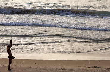 Man doing yoga on Jaffa beach, Jaffa, Israel, Middle East