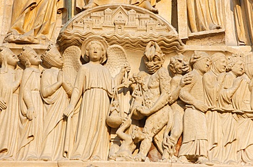 Last Judgment gate tympanum showing the angel St. Michael weighing souls, west front, Notre Dame Cathedral, UNESCO World Heritage Site, Paris, France, Europe