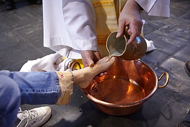 Feet washing ritual during Maundy Thursday celebration in a Catholic church, Paris, France, Europe