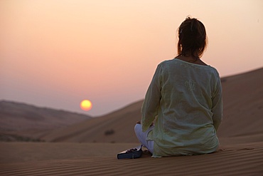 Woman with Bible in the desert, Abu Dhabi, United Arab Emirates, Middle East