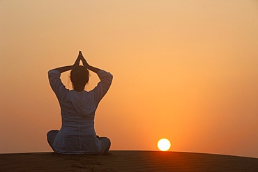 Sunset meditation in the desert, Abu Dhabi, United Arab Emirates, Middle East