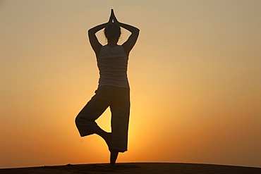 Sunset meditation in the desert, Abu Dhabi, United Arab Emirates, Middle East