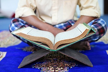 Muslim man reading the Quran in mosque, Ho Chi Minh City, Vietnam, Indochina, Southeast Asia, Asia