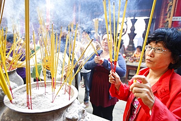 Burning incense during Tet, the Vietnamese lunar New Year celebration, Thien Hau Temple, Ho Chi Minh City, Vietnam, Indochina, Southeast Asia, Asia