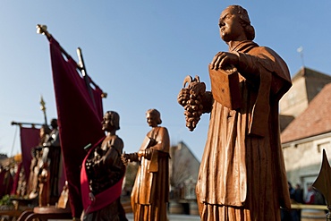 Wooden statues of patron saints during the annual festival of Saint Vincent Tournante (Turning St. Vincent), held in one of the wine producing villages in Burgundy, created in 1938 by the Confrerie des Chevaliers du Tastevin (Confraternity of the Knights of winecup), Corgoloin, Burgundy, France, Europe