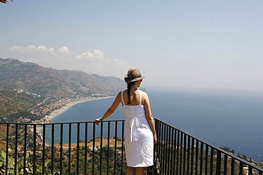 Woman looking at Taormina Bay, Taormina, Sicily, Italy, Mediterranean, Europe