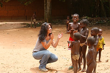 French woman playing wih African children, Tori, Benin, West Africa, Africa