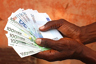 African holding Euros, Lome, Togo, West Africa, Africa