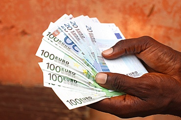 African holding Euros, Lome, Togo, West Africa, Africa