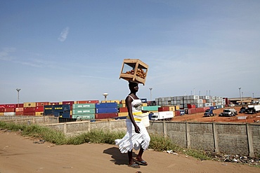 African woman carrying a load on her head., Lome, Togo, West Africa, Africa