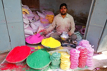 Man selling colored powders for Holi festival, Barsana, Uttar Pradesh, India, Asia