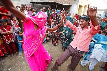 Dancing in the street during Holi celebration in Goverdan, Uttar Pradesh, India, Asia