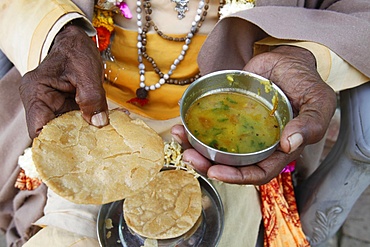 Sadhu eating vegetarian food, Dauji, Uttar Pradesh, India, Asia