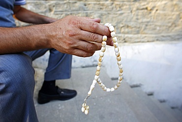 Man holding prayer beads, Baku, Azerbaijan, Central Asia, Asia