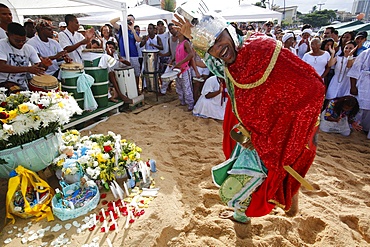 Entranced devotee embodying Orixa (Orisha) Oxosse during Lemnaja festival on Rio Vermelho beach, Salvador, Bahia, Brazil, South America