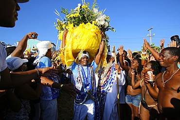 Flower offerings to Lemanja carried by a Son of Gandhi, Lemanja festival in Rio Vermelho, Salvador, Bahia, Brazil, South America