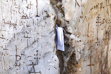 In the cracks of the stone pillars some believers insert prayer notes, Holy Sepulchre Church, Jerusalem, Israel, Middle East