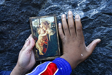 Pilgrims touching the Lourdes grotto, Lourdes, Hautes Pyrenees, France, Europe