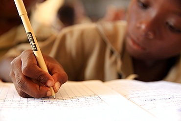 Pupil taking notes in French class in African primary school, Lome, Togo, West Africa, Africa