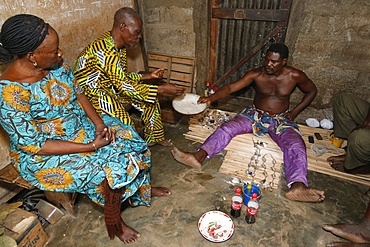 Couple visiting a fortune teller in Ouidah, Benin, West Africa, Africa