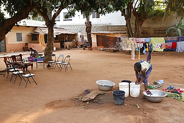 African woman doing the dishes, Lome, Togo, West Africa, Africa