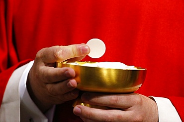 Catholic priest giving Holy Communion, Paris, France, Europe