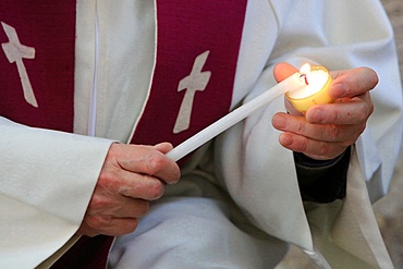 Lighting a candle on Day celebration of forgiveness, Amiens Cathedral, Picardy, France, Europe