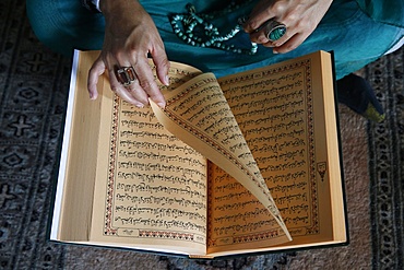 Muslim woman reading Kuran, Montrouge, Hauts-de-Seine, France, Europe