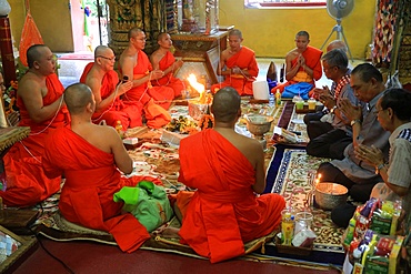 Buddhist monks praying, Sai Sin, the cotton thread symbolizing the sacred bond, Wat Simuong (Wat Si Muang), Vientiane, Laos, Indochina, Southeast Asia, Asia