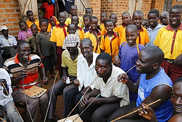 Ugandan villagers drinking home-brewed beer and schoolchildren, Bweyale, Uganda, Africa