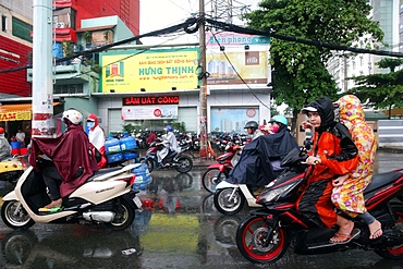 Motor scooters on Saigon Street in heavy monsoon rain, Ho Chi Minh City, Vietnam, Indochina, Southeast Asia, Asia