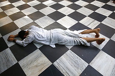 Hindu devotee prostrating at Krishna-Balaram temple, Vrindavan, Uttar Pradesh, India, Asia