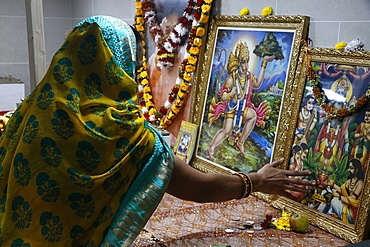 Faithful touching pictures of deities, Shree Ram Mandir, Leicester, Leicestershire, England, United Kingdom, Europe