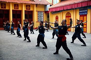 Men practising martial arts in a Buddhist temple, Ho Chi Minh City, Vietnam, Indochina, Southeast Asia, Asia