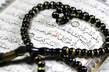 Quran and Tasbih (prayer beads) with Allah monogram in red, Haute-Savoie, France, Europe