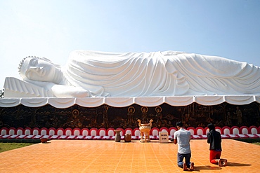 Worshippers praying to the Reclining Buddha, Chua Thien Lam pagoda, Tay Ninh, Vietnam, Indochina, Southeast Asia, Asia