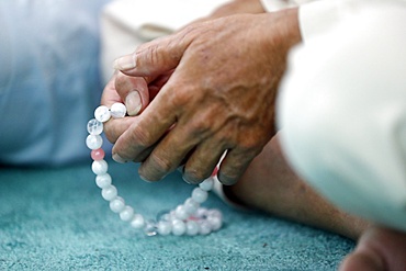 Close-up of man praying in a mosque with Tasbih (prayer beads), Masjid Al Rahim Mosque, Ho Chi Minh City, Vietnam, Indochina, Southeast Asia, Asia